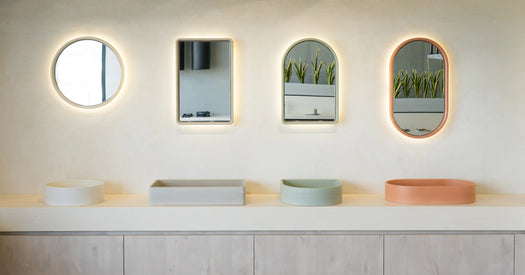 A wide angle view of the different concrete basin designs and matching concrete mirrors with LED backlighting.