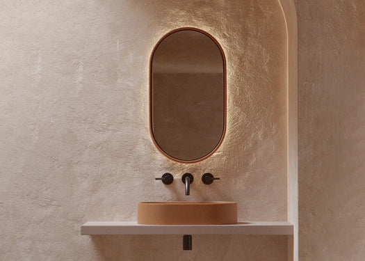 A modern microcement rendered bathroom with a matching Lunar Concrete Mirror and Eclipse Concrete Basin on a float concrete vanity top.