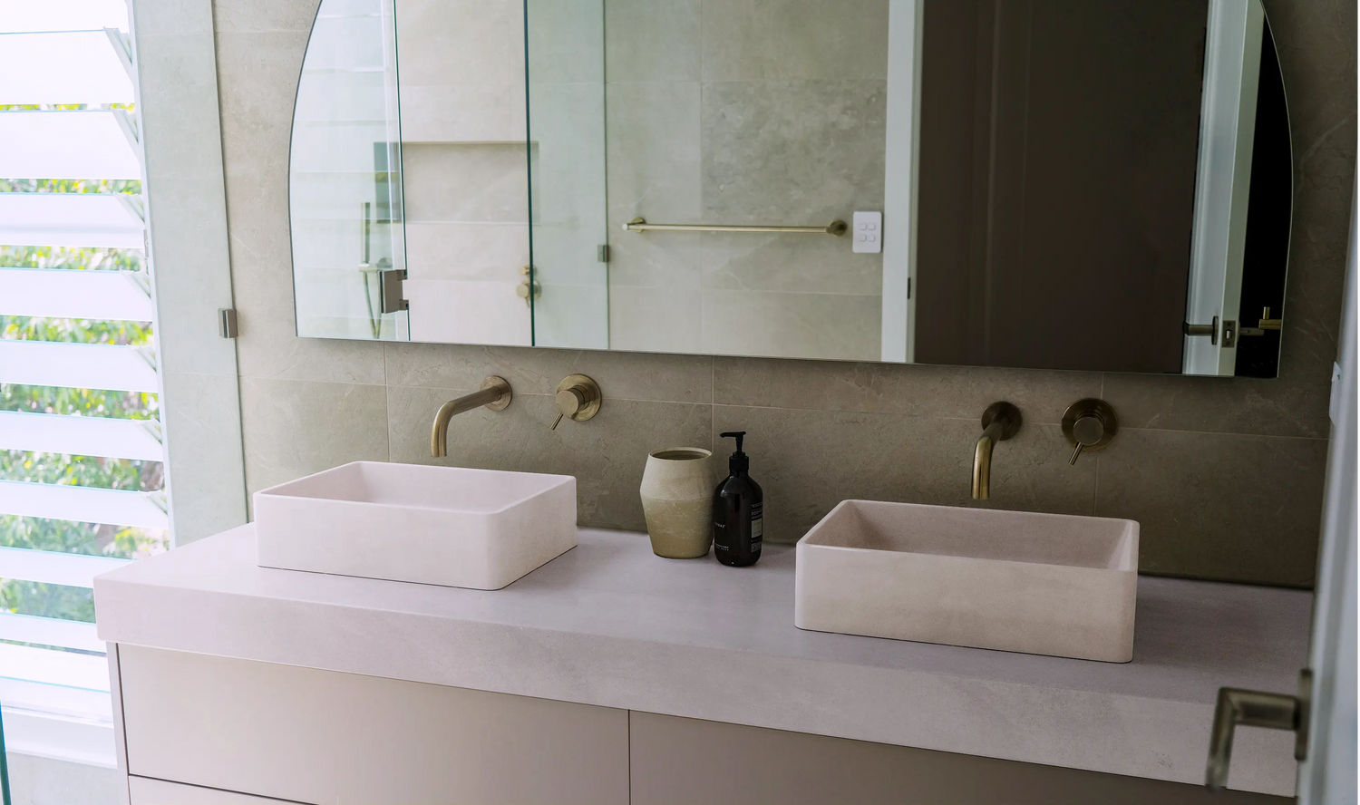 A well light bathroom with his and hers matching Nova Concrete Basins in the colour whitehaven.