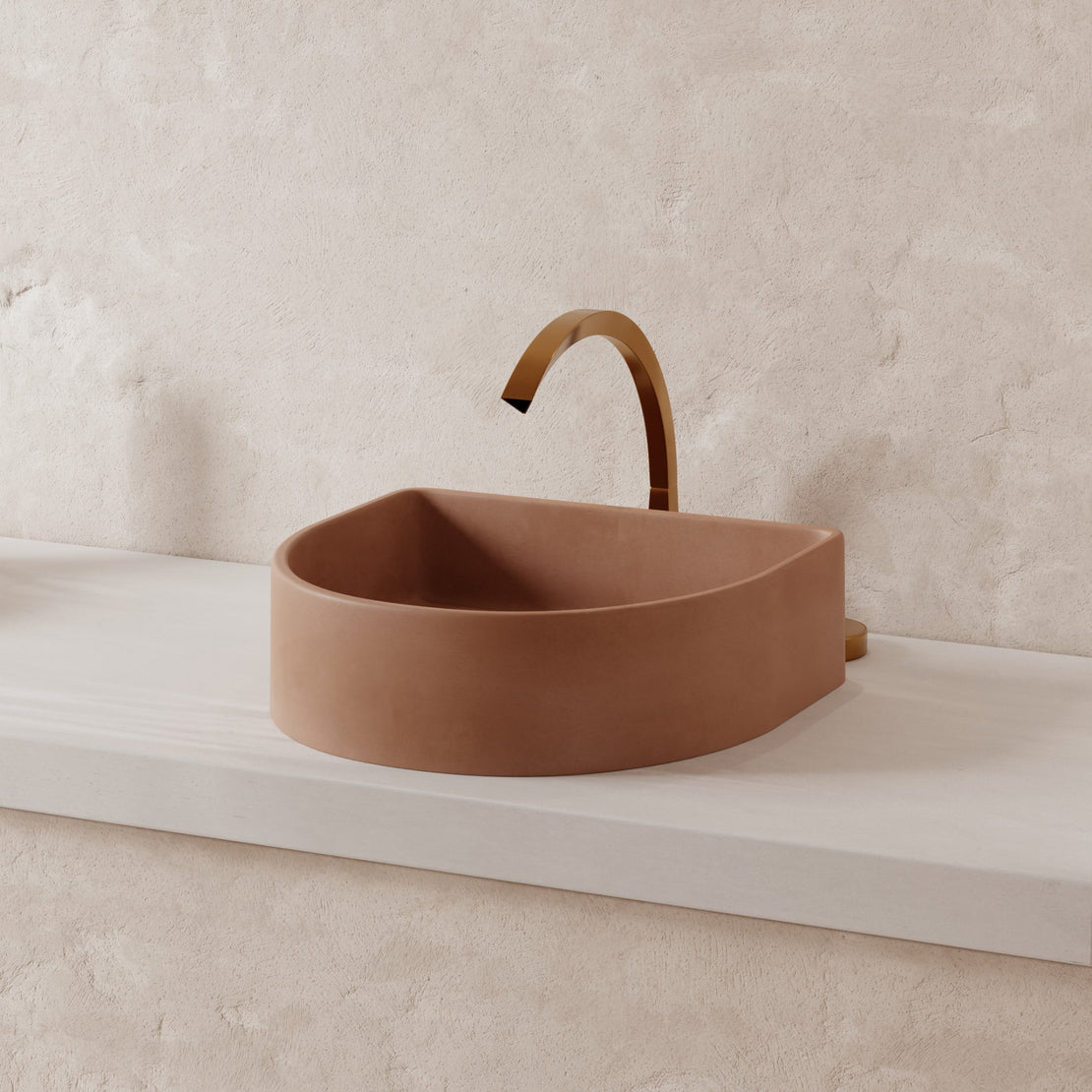 The Crescent Concrete Basin in the colour Dingo on a cream vanity top with a beige rendered wall behind