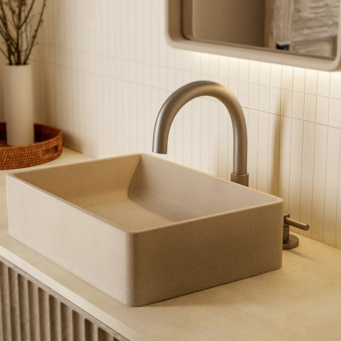 The Nova Concrete Basin in a neutral coloured basin with silver toned tapware and cream tiling.