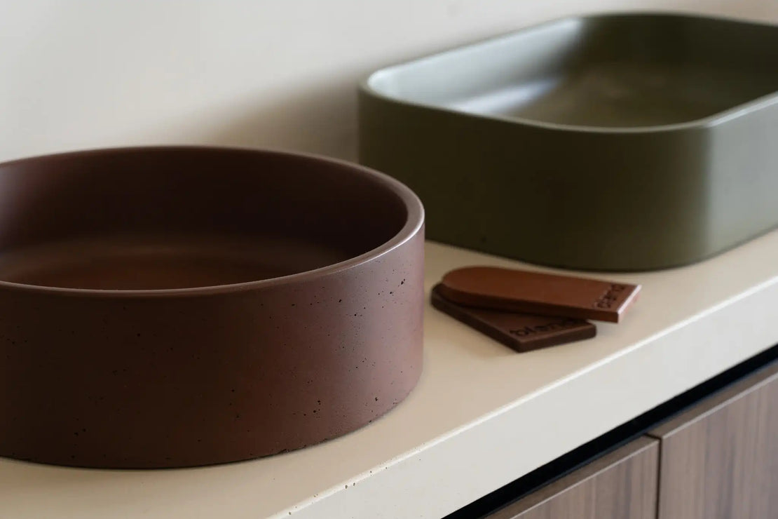 The Comet Concrete Basin and the Titan Concrete Basin placed on a benchtop in the Blend showroom.