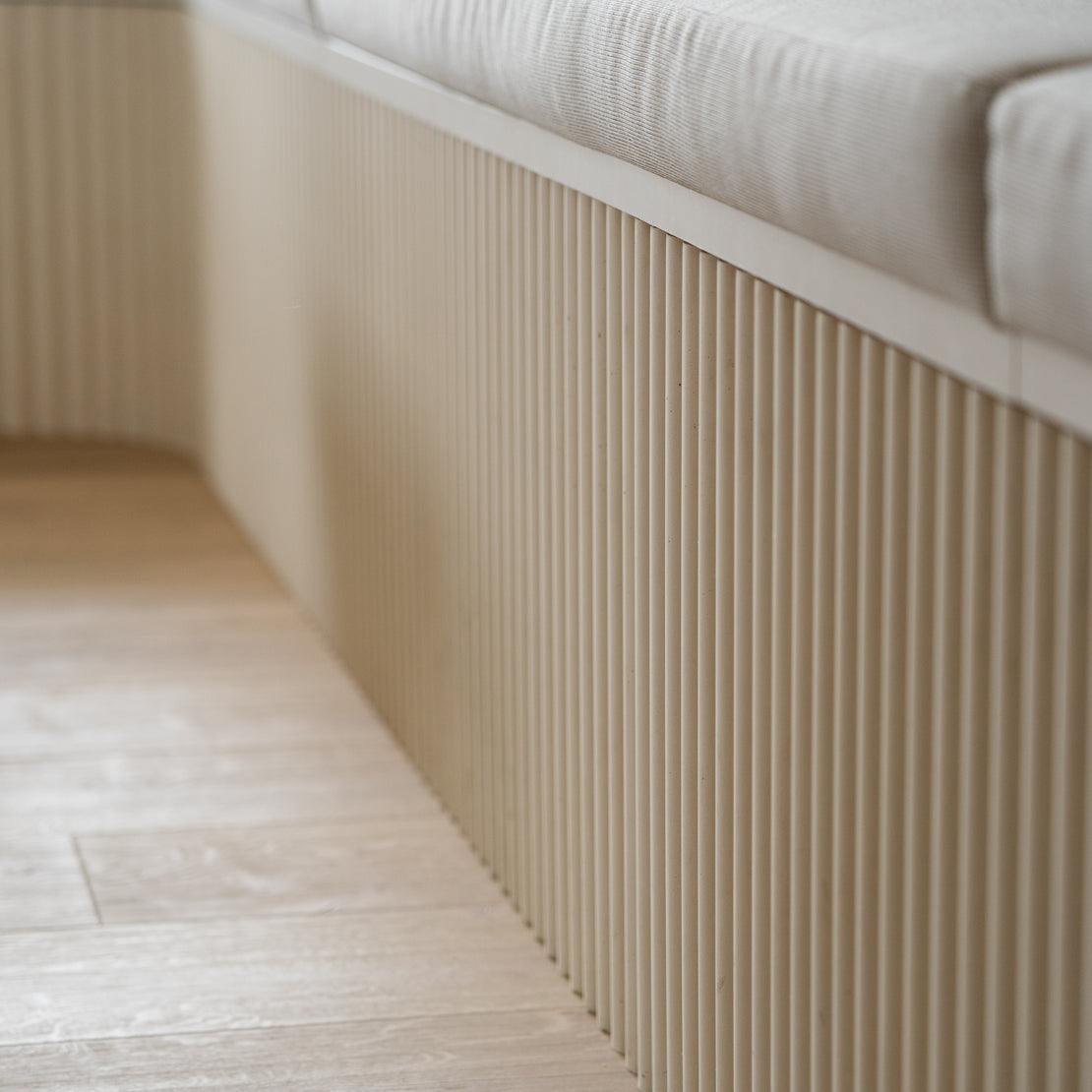 Custom concrete fluting for the bottom half of bench seating.