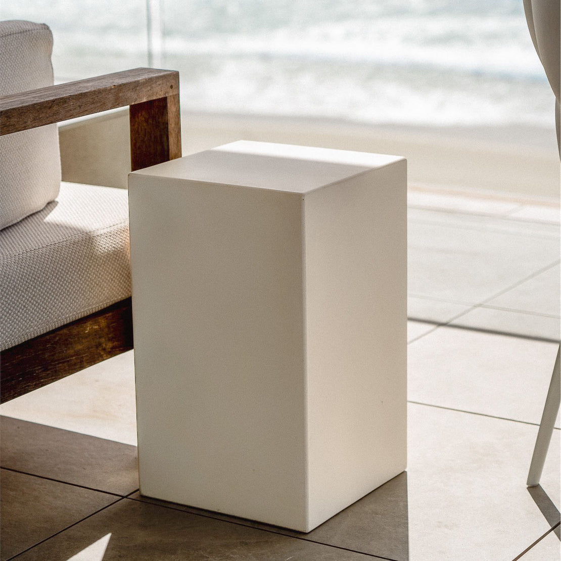 The Sahara Concrete Side Table shows off its rectangular, block shaped form at this seaside residence.