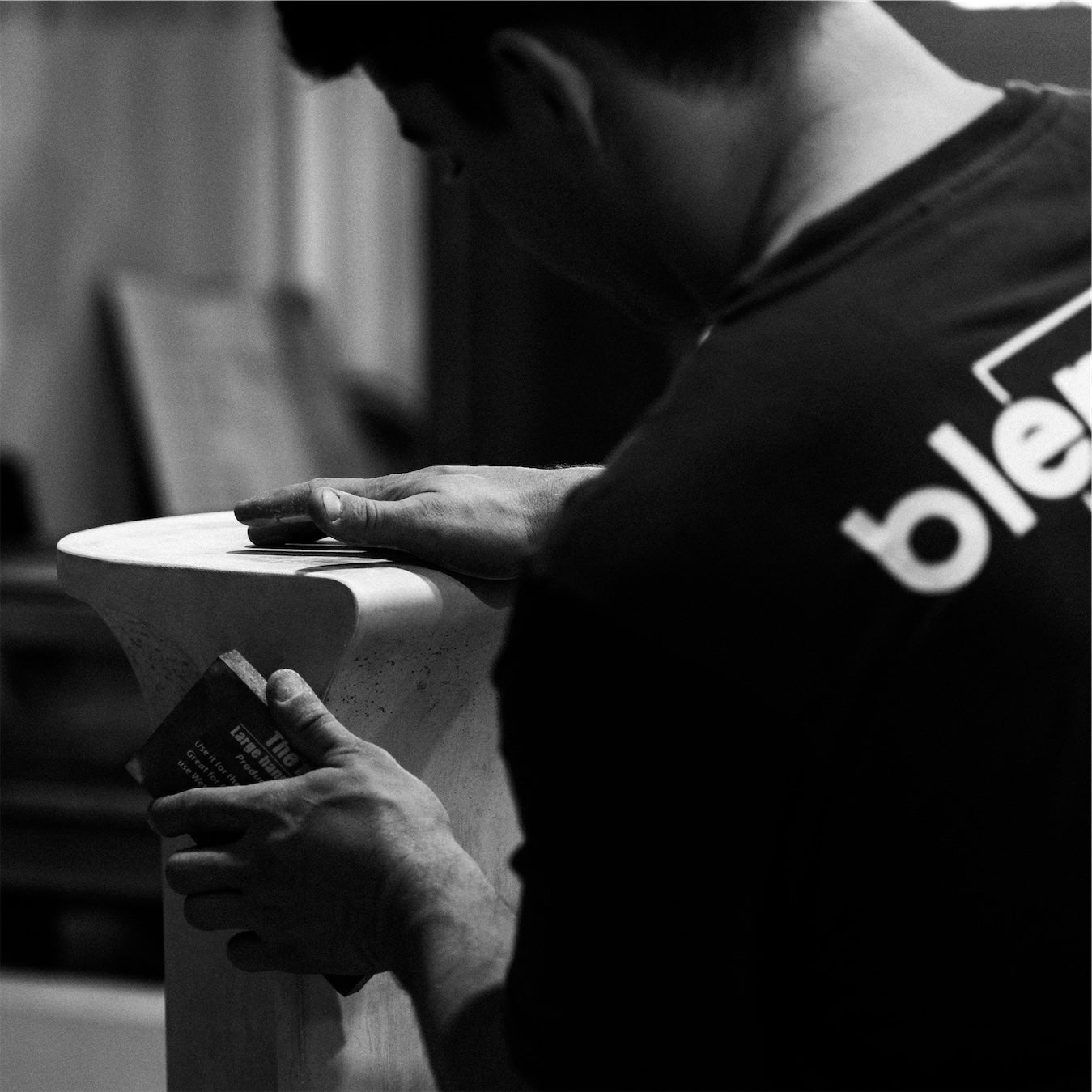 Close up photo of a Blend Concrete Design concrete artisan sanding a concrete side table 