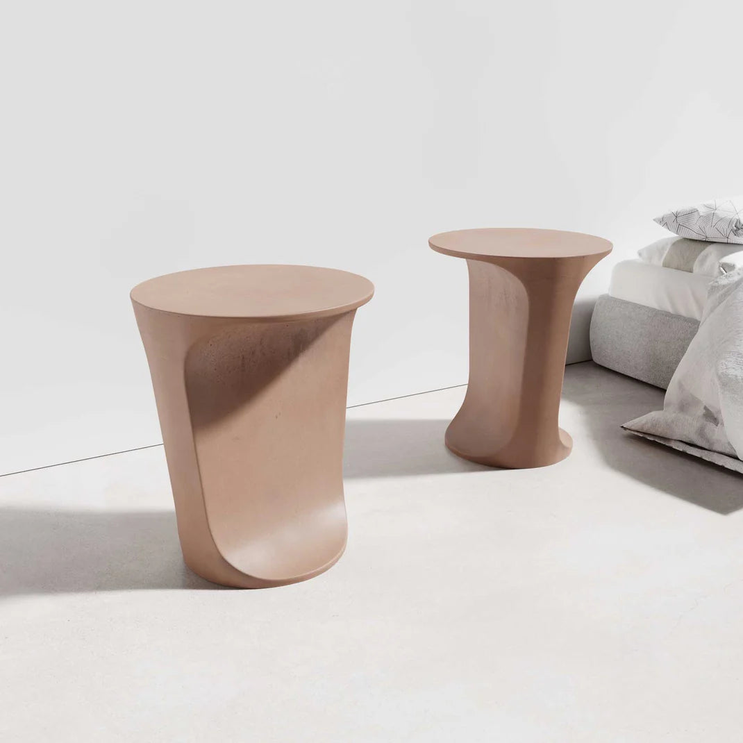 Two Alpine Concrete Side Tables in the concrete colour Dingo, featuring smooth, curved bases and round tops.