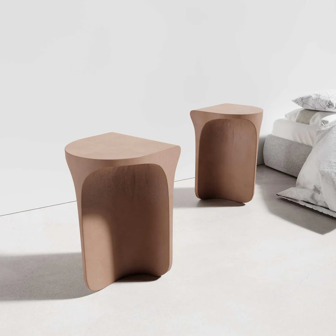 Two Isle Concrete Side Tables in the concrete colour Dingo, showcasing unique arc shaped tops and curved bases