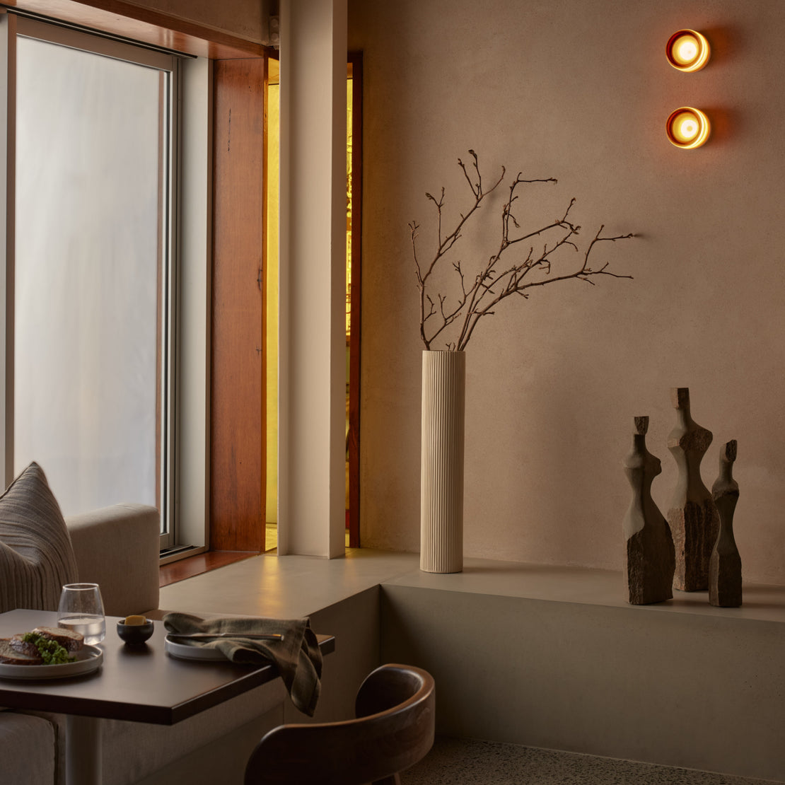 An image of the corner of a restaurant that has a custom concrete banquet seating bench.