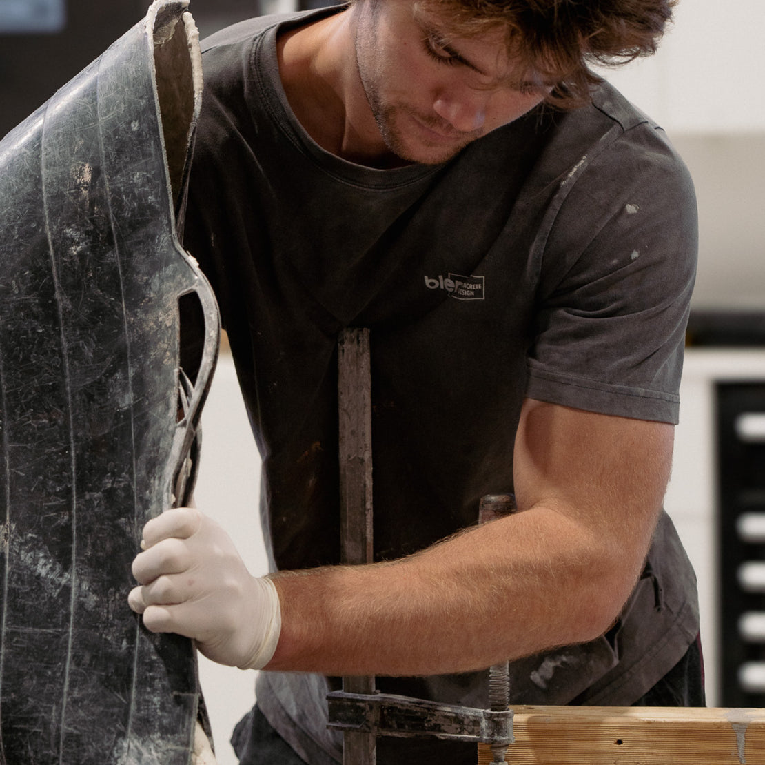 A concrete maker pouring concrete into a mold.