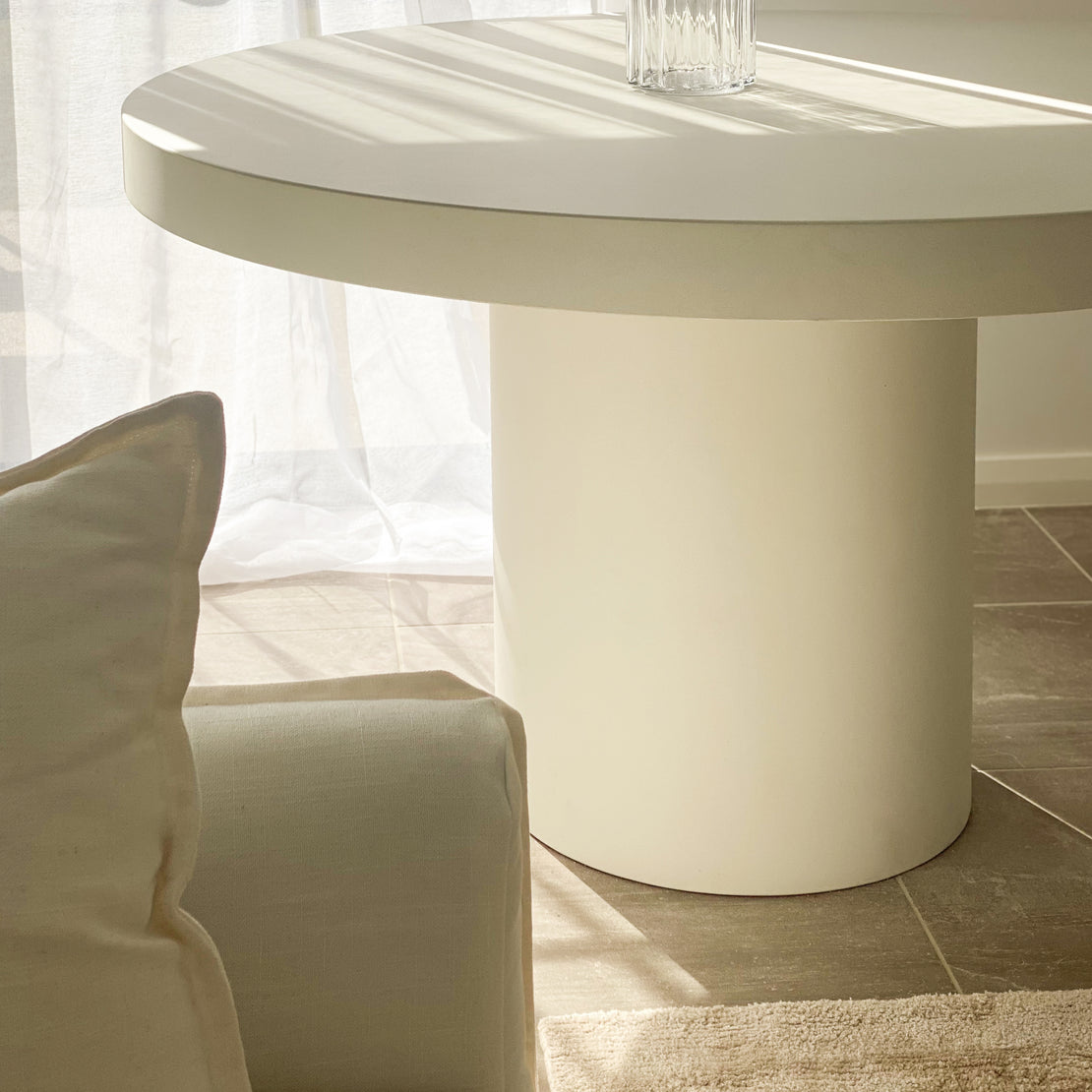 Afternoon sunlight shining on a small Tuscan Concrete Dining Table in Whitehaven.