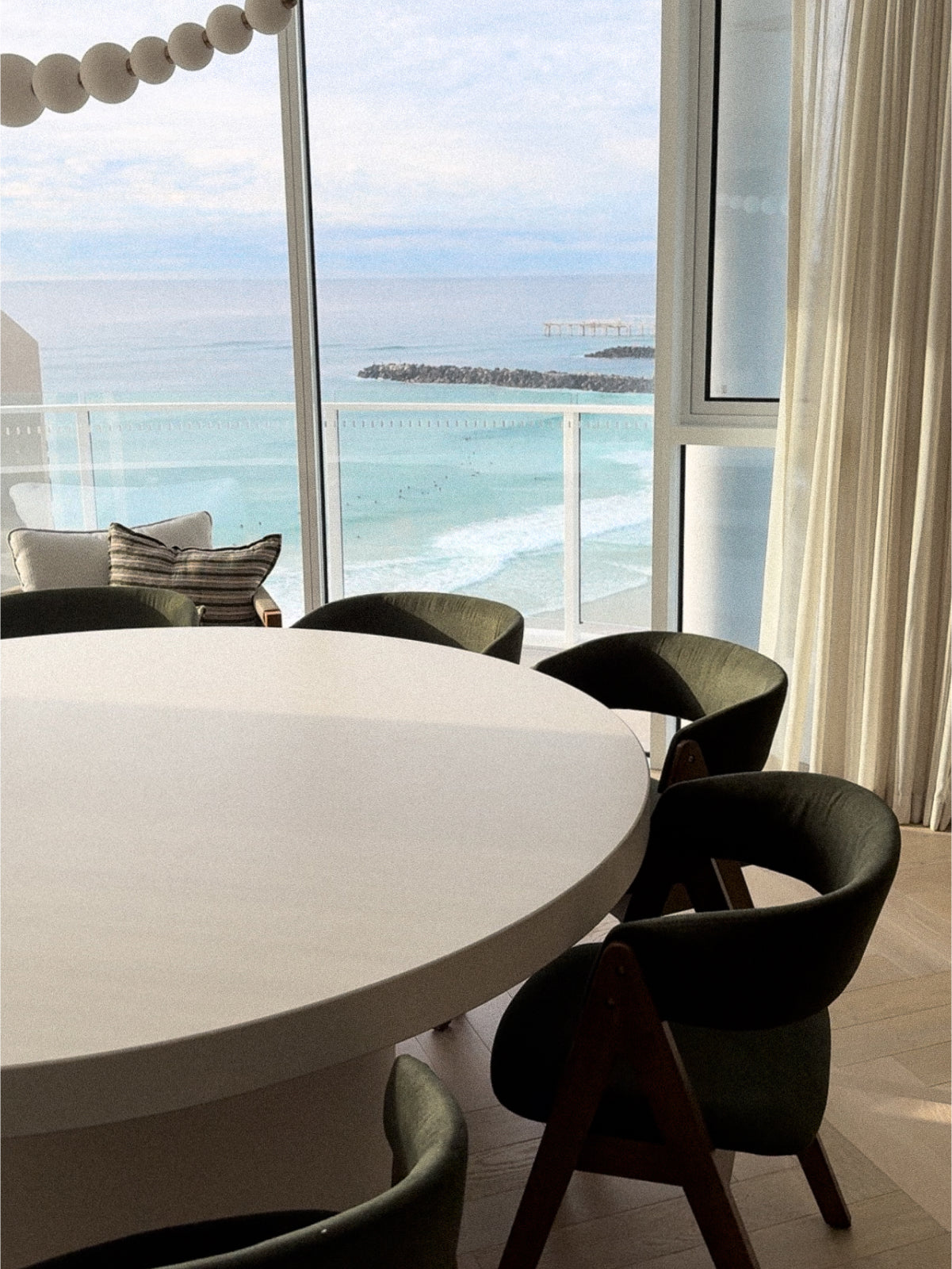 Large Tuscan Concrete Dining Table in Whitehaven in a apartment overlooking a beach