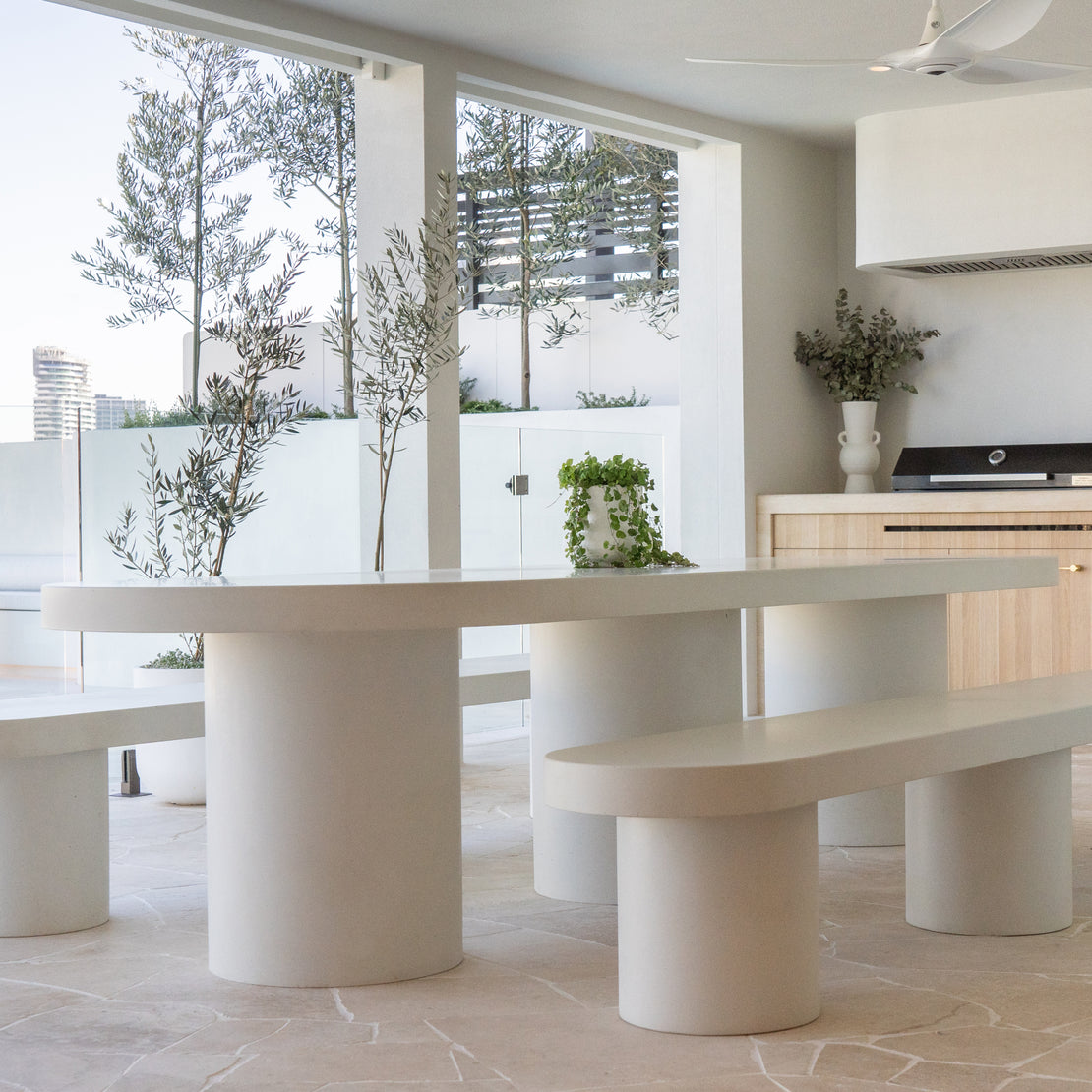 The Umbria Concrete Dining Table in a neutral outdoor entertaining area.