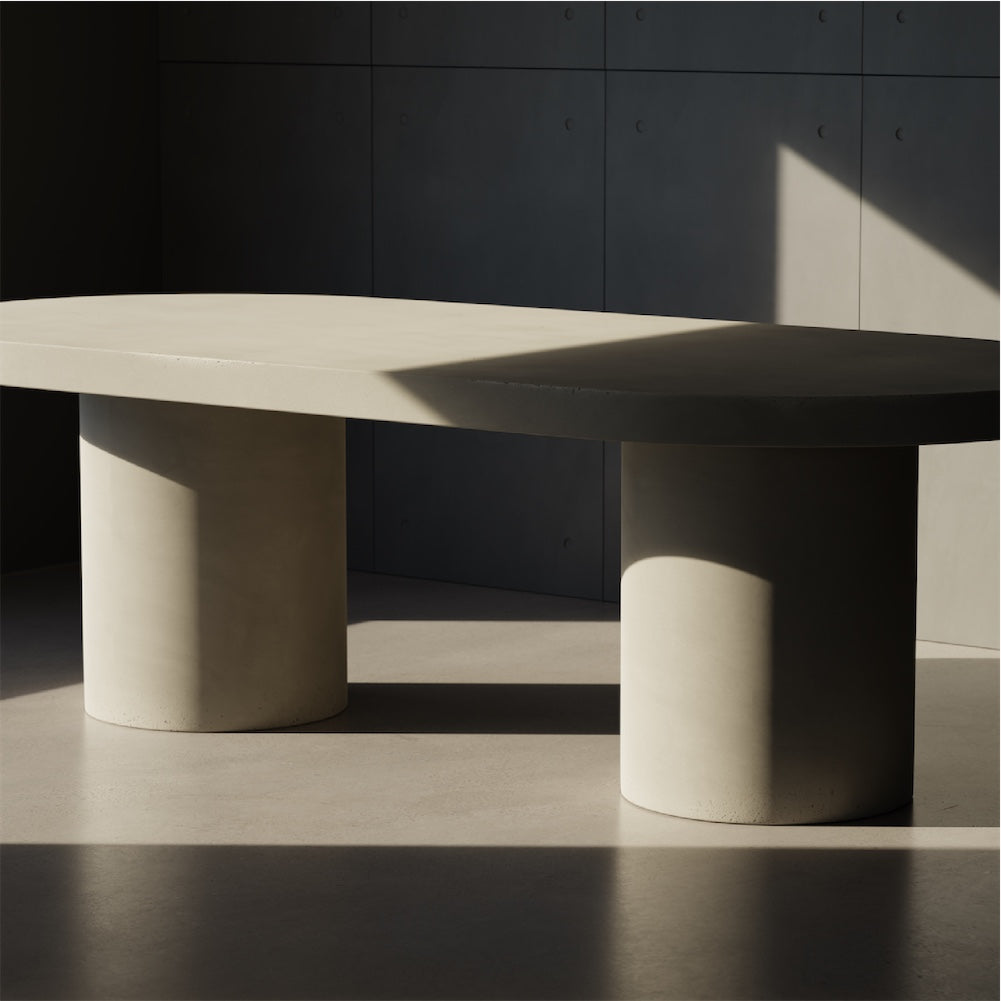 A Verona Concrete Dining Table positioned in front of a wall of Concrete Panels 