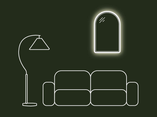 A Arc Concrete LED Mirror on a wall behind a sofa, accompanied by a standing lamp.