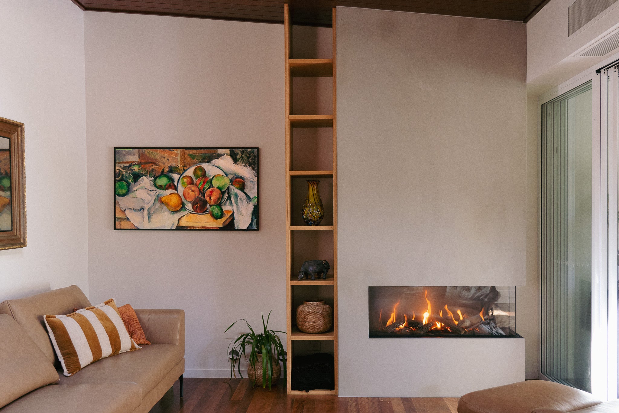 A wide angle of a custom concrete fireplace.