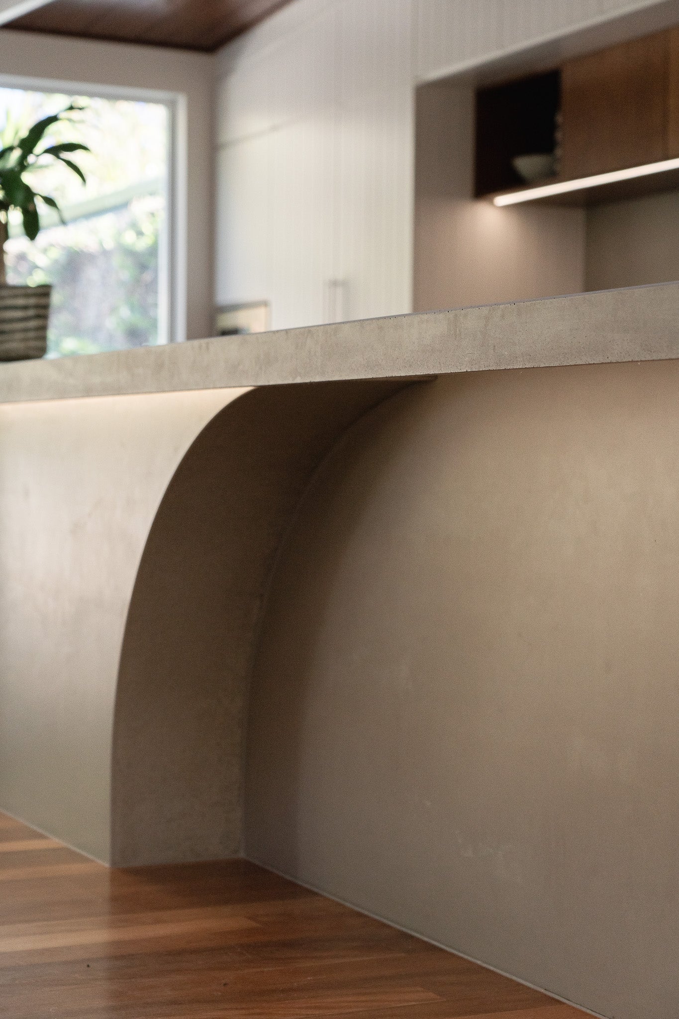 A close up angle of a curve concrete kitchen bench in a residential kitchen.