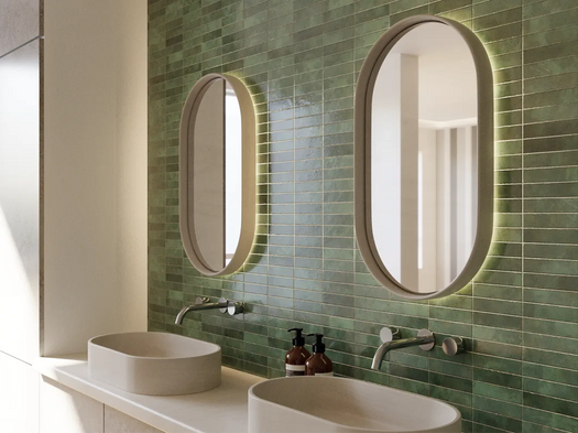 Two sets of the Lunar Concrete LED mirror and Eclipse Concrete Basin in a green modern bathroom.