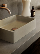 A Nova Concrete Basin in the colour Mist Grey on a concrete vanity unit in a modern bathroom.