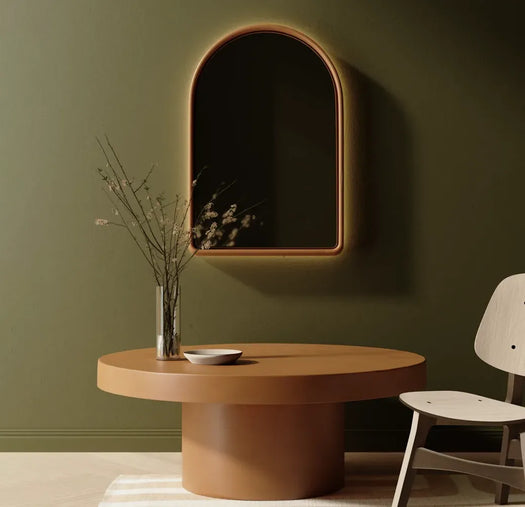 A Dingo Arc Concrete LED Mirror and Dingo Siena Concrete Coffee Table in a green livingroom.