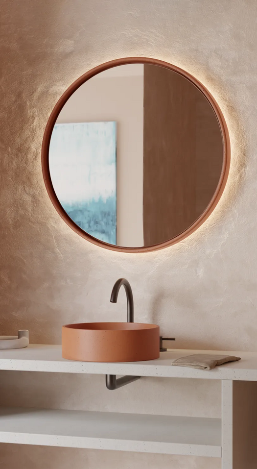 A large round Sol Concrete LED mirror with a matching round Comet Concrete basin in a modern minimalist bathroom.