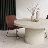 Sand Tuscan Concrete Dining Table is a round dining table is a modern dining room with beige tiles and brown leather chairs.