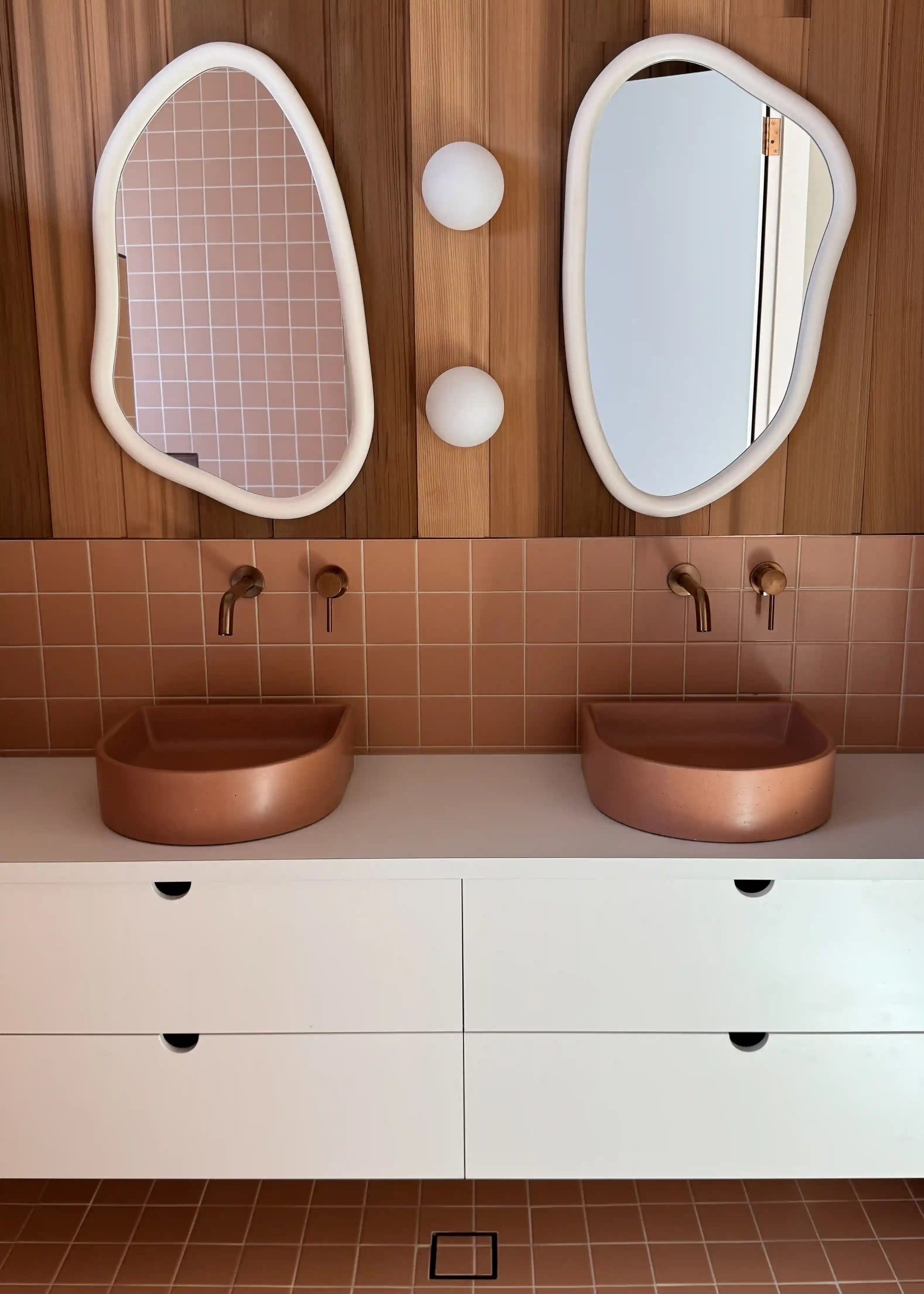 A set of two Crescent Concrete Basins in the colour Dingo in an ornate bathroom.