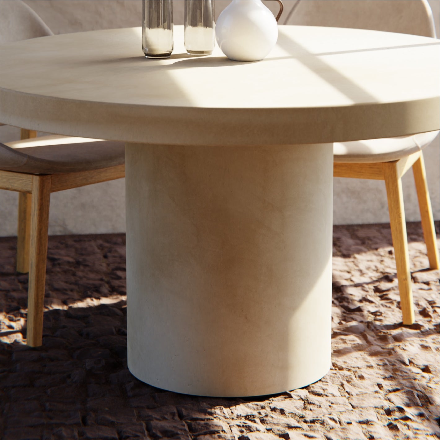 A Tuscan Concrete Dining Table sitting outside in front of a rendered wall with a timber chair arrangement. 